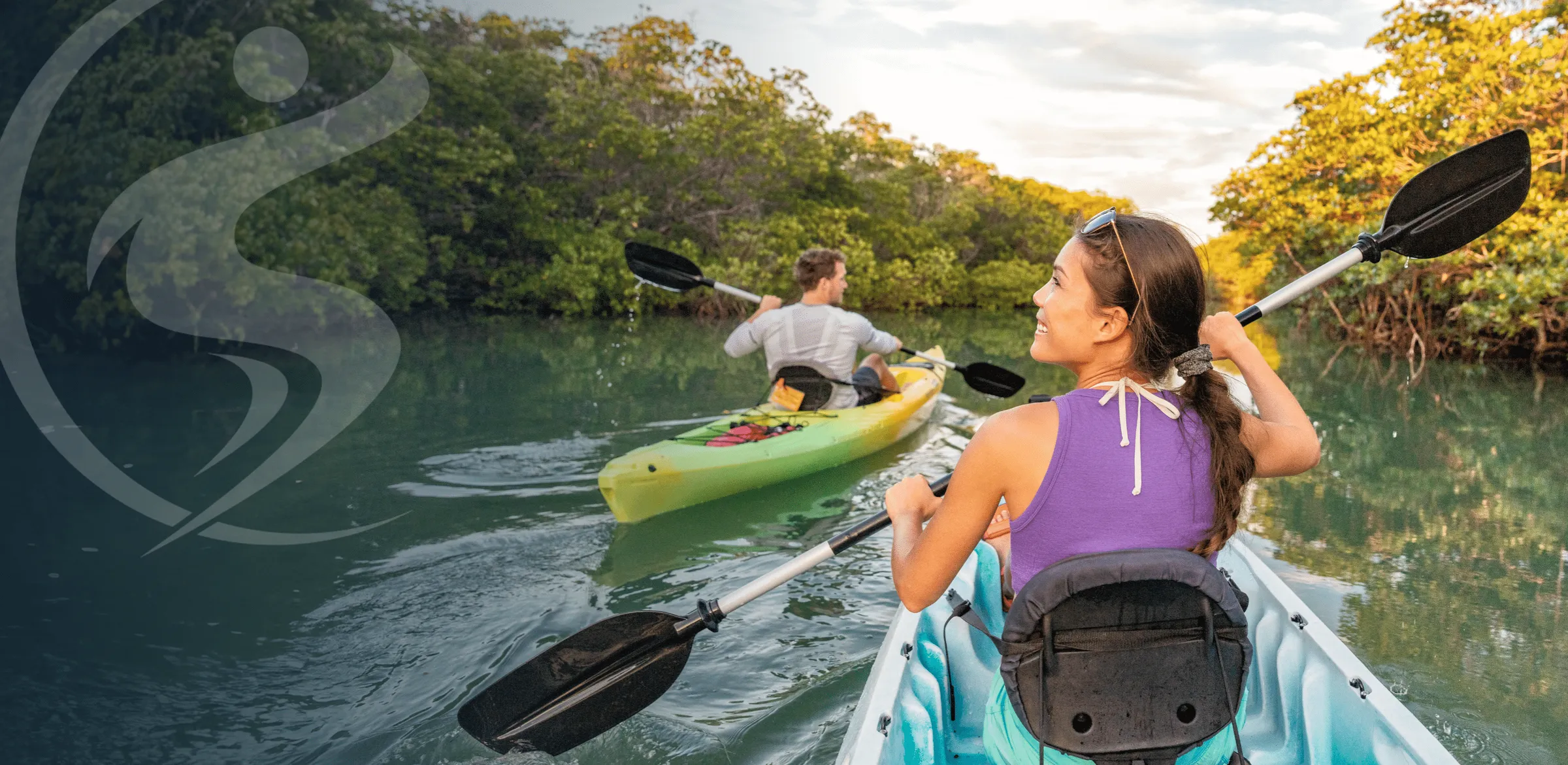 Woman and man kayaking together on the water.