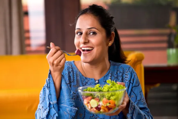 Woman eating a salad out of a bowl