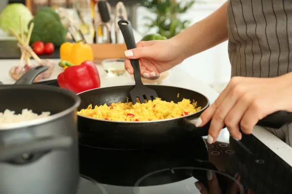Woman stirring rice in a pot