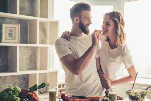 Couple happily standing in front of kitchen counter