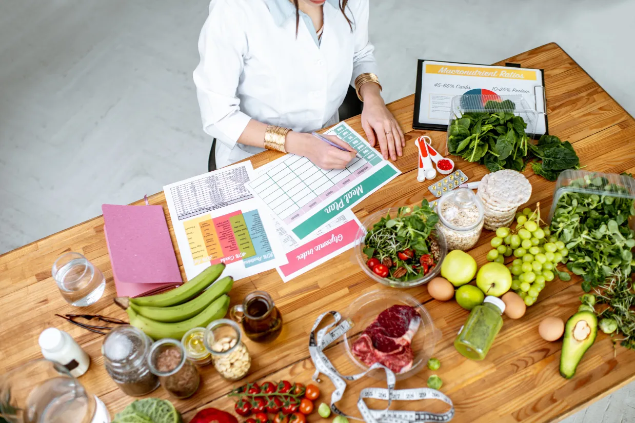 Woman with food on table surrounding her