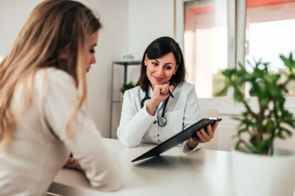Doctor talking to patient with clipboard