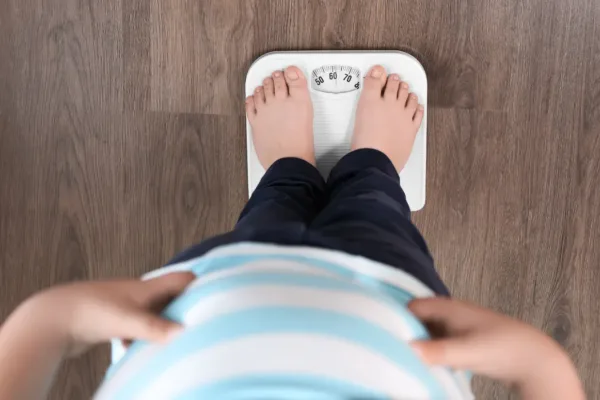 Person taking a photo of feet on a weight scale