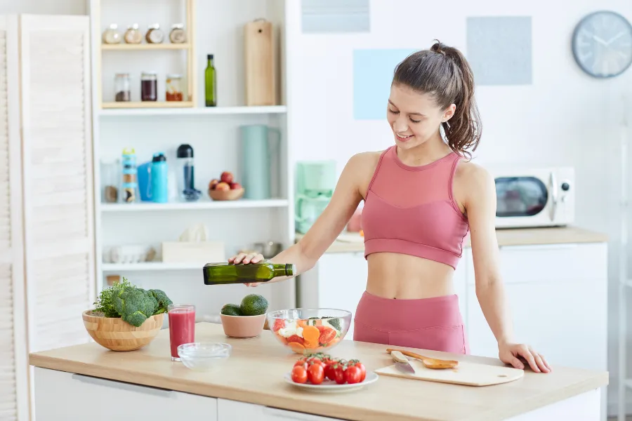 Woman with healthy foods in front of her on table
