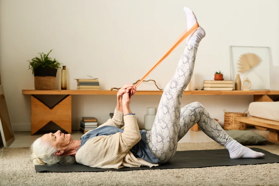Woman stretching with band on floor