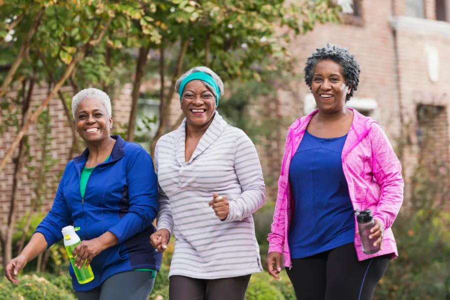 Three older woman outdoors smiling
