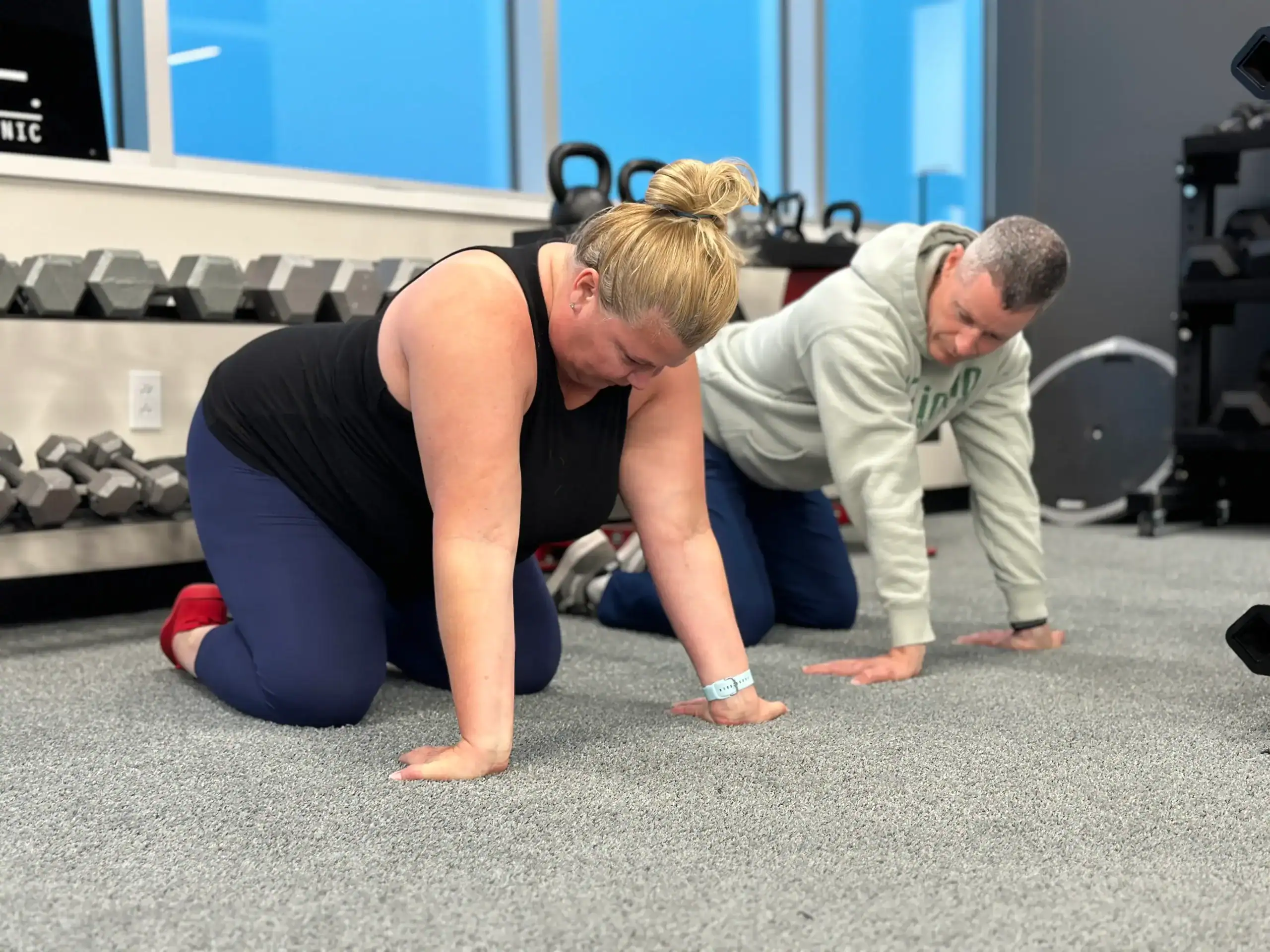 Physical Trainer with happy client in action